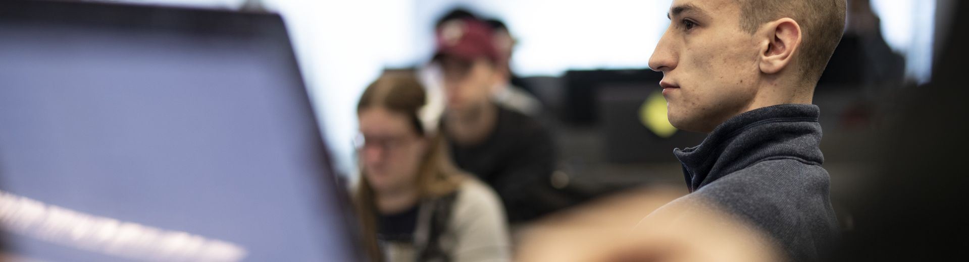 A student sits attentively in a classroom at Temple University.