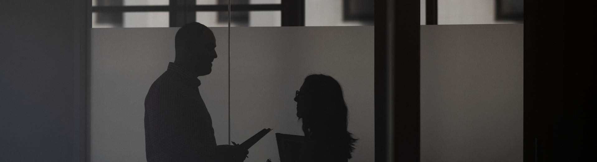 shadow image of two people having a discussion.