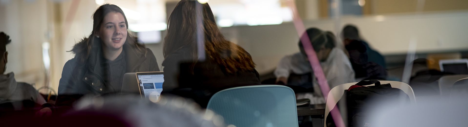 Two students engaged in conversation at Temple University.