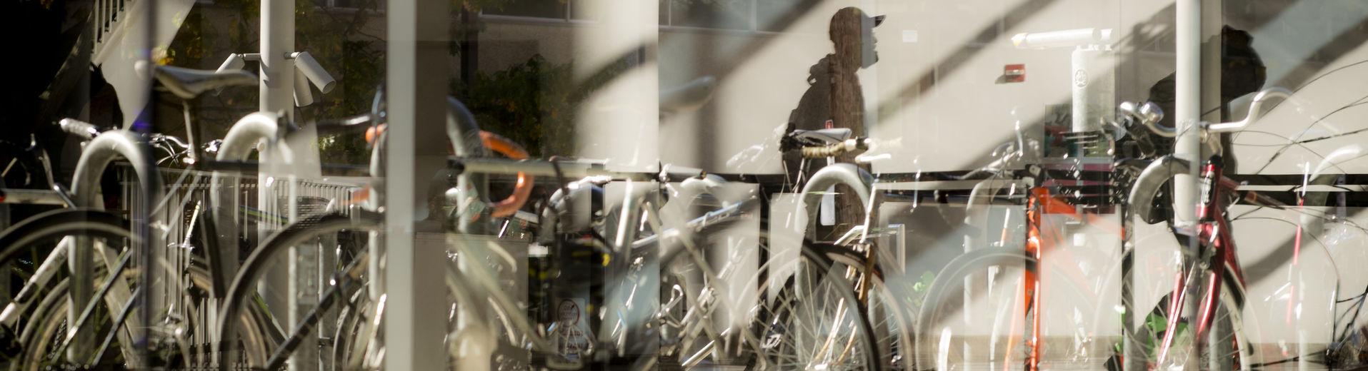 abstract image of bicycles parked outside a building on Main Campus. 