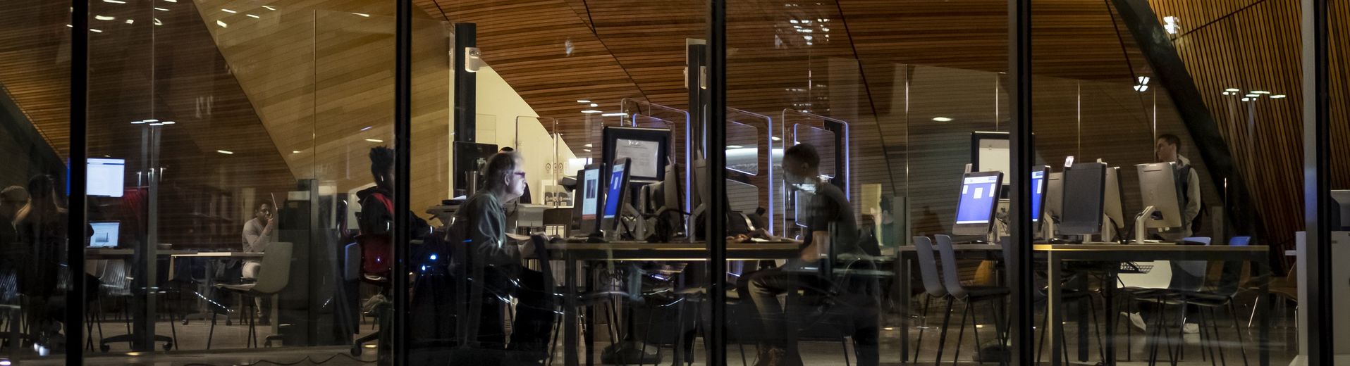 Students are studying at night in Charles Library