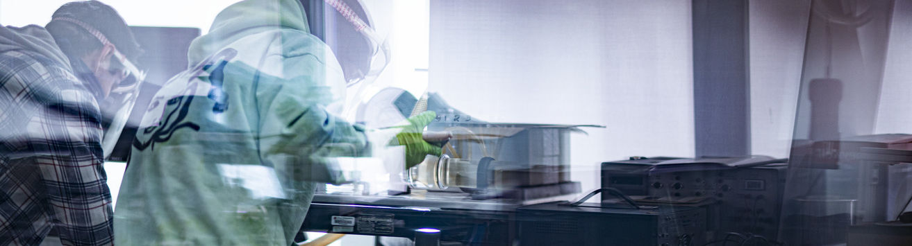 A pair of Temple students working in an engineering lab.