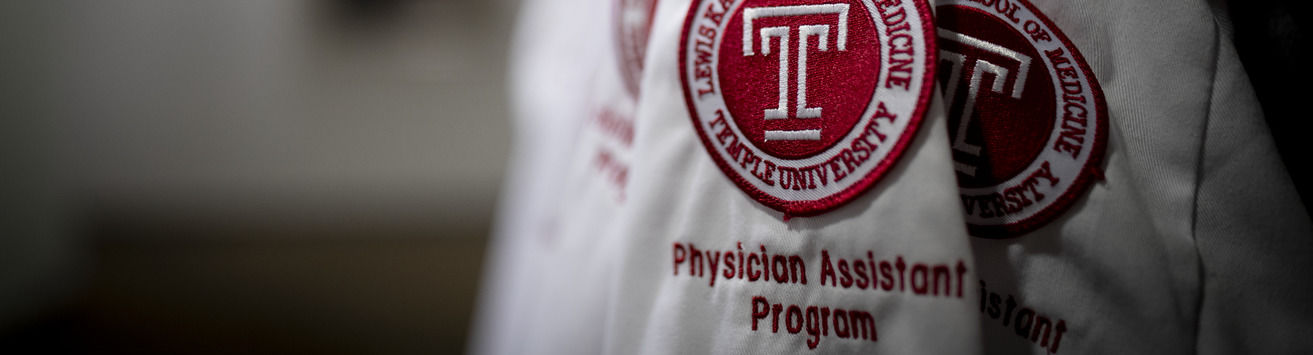 A close up of a white coat with the Katz School of Medicine logo that says Physician Assistant program