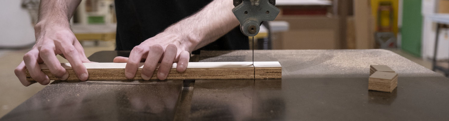 An image of a student using a tool to create a sculpture