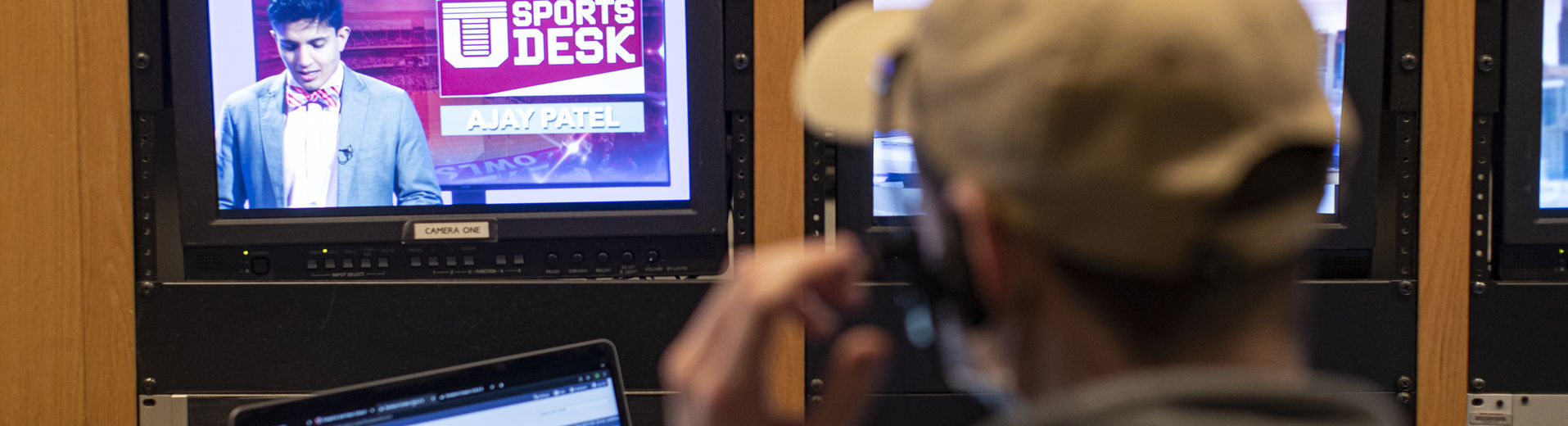 A Klein student working production behind the scenes in a television studio