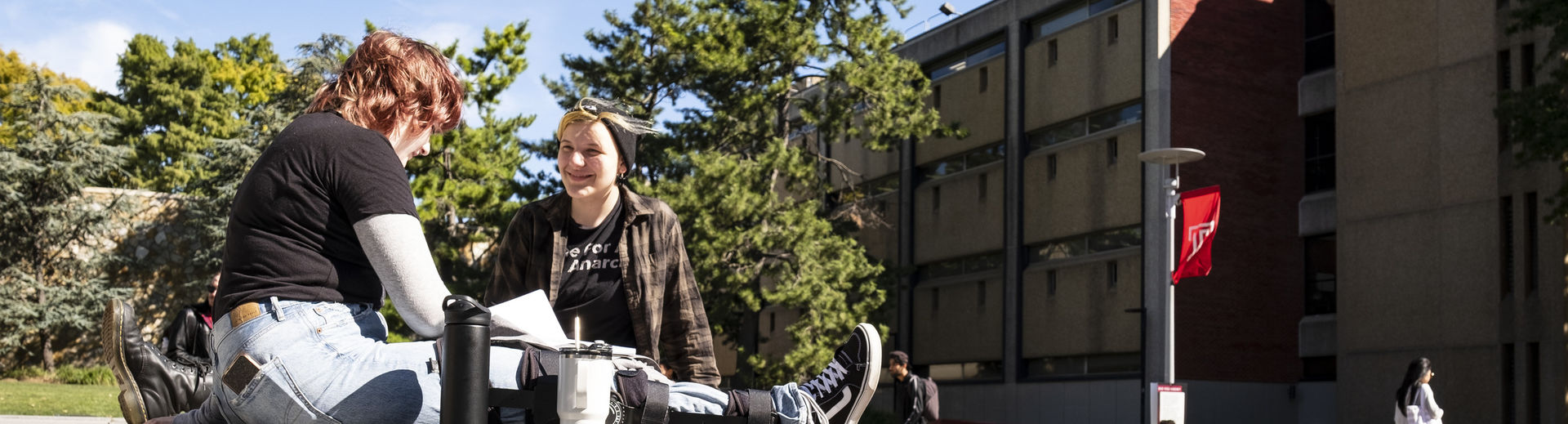 two students chatting outside on Main Campus. 