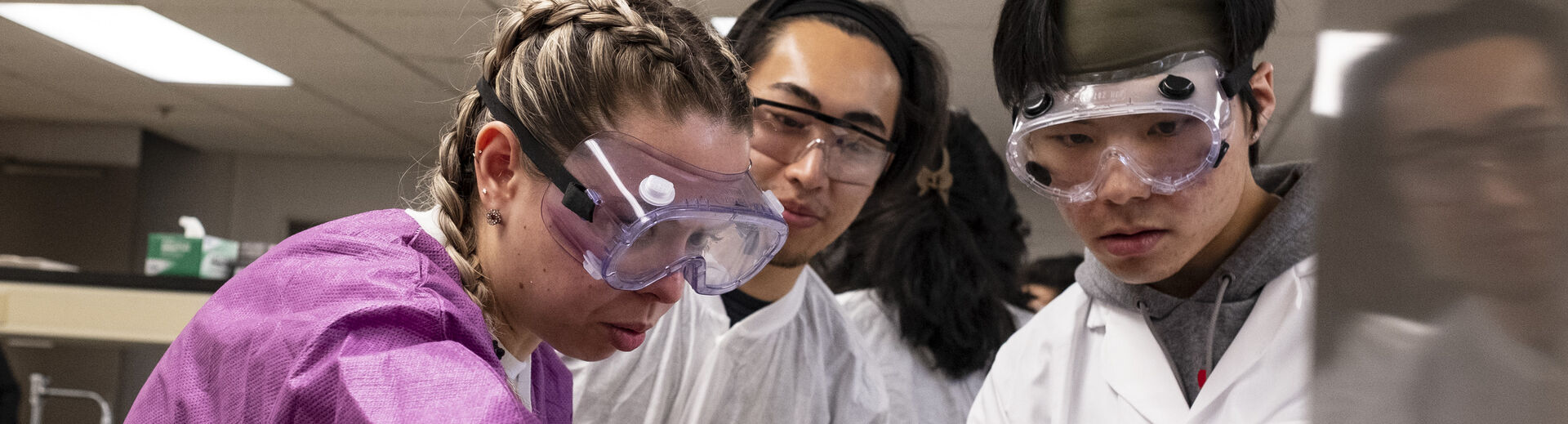 three chemistry students working in the lab.