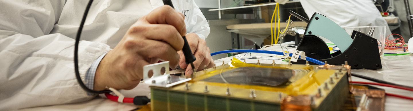 An image of an instructor conducting a physics experiment.