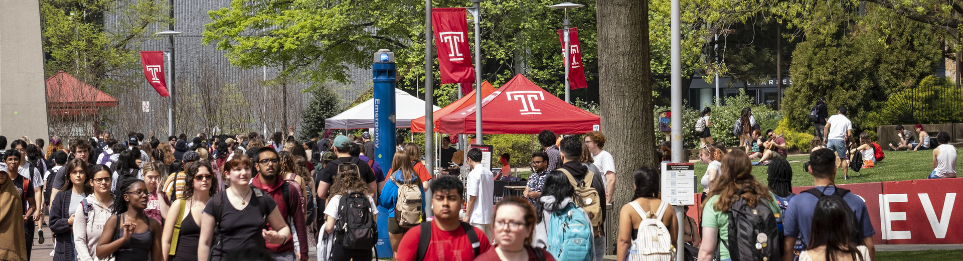 Students traveling on Temple's Main Campus on a sunny spring day