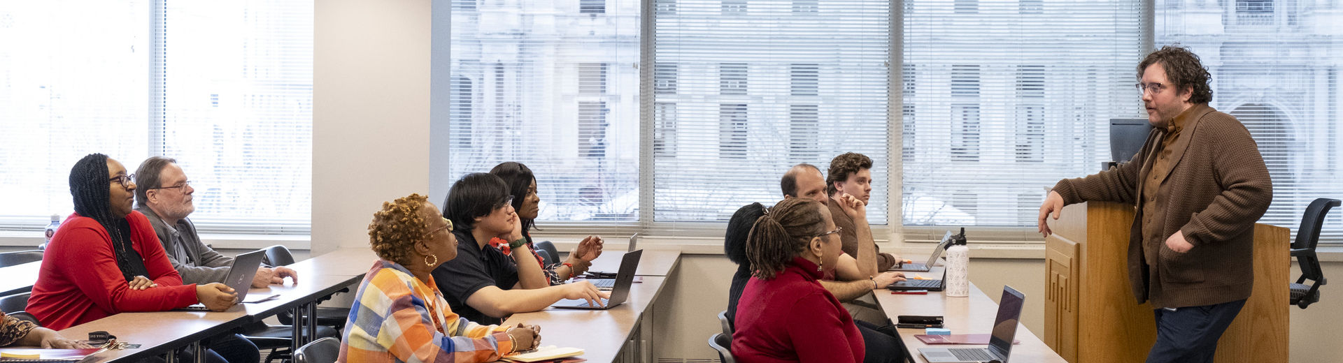 adult students listening to their instructor during class.