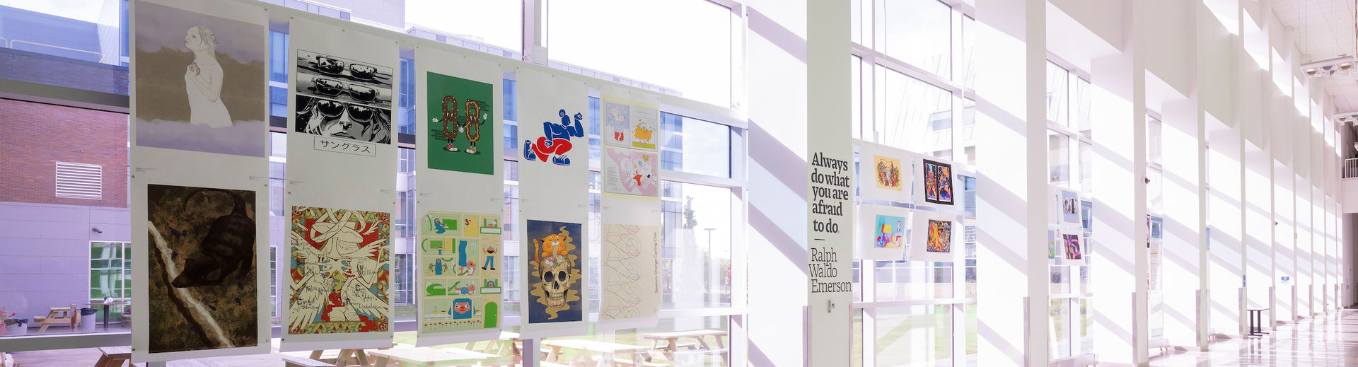 A sunny hallway in the Tyler building displaying student illustrations.