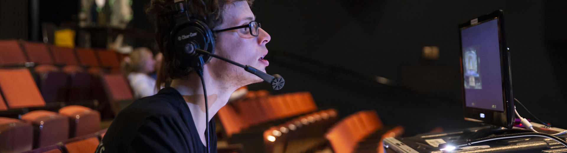 A Temple student runs the lighting board for a theater production.