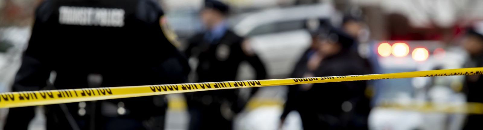 Police cordon off a crime scene using yellow "police tape."
