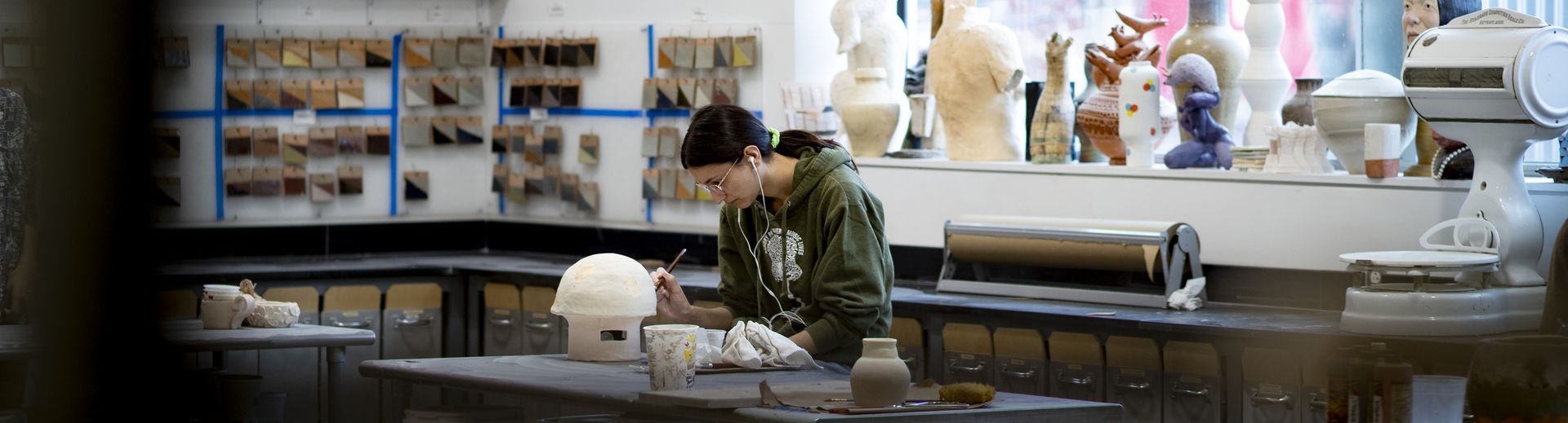 student adding details to their ceramics project.