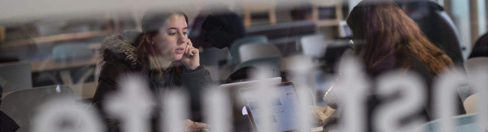 A student studies in the lounge at the Fox School of Business.