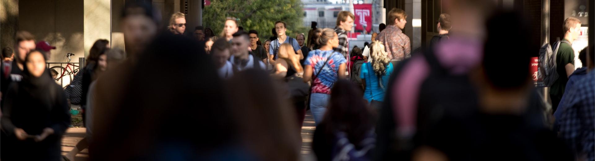 student walking on campus during a class change 