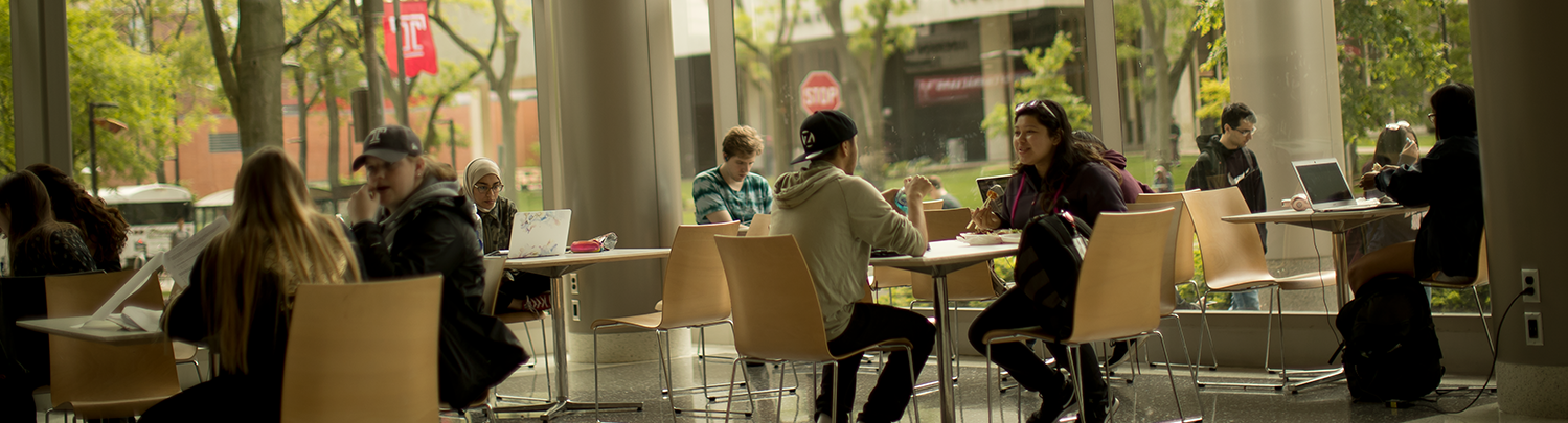 Students sitting and talking on Temple campus