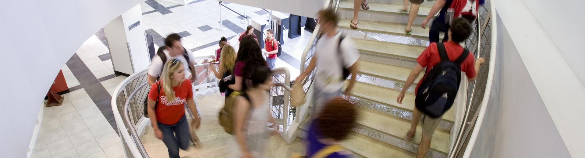 students walking to class up a spiral staircase