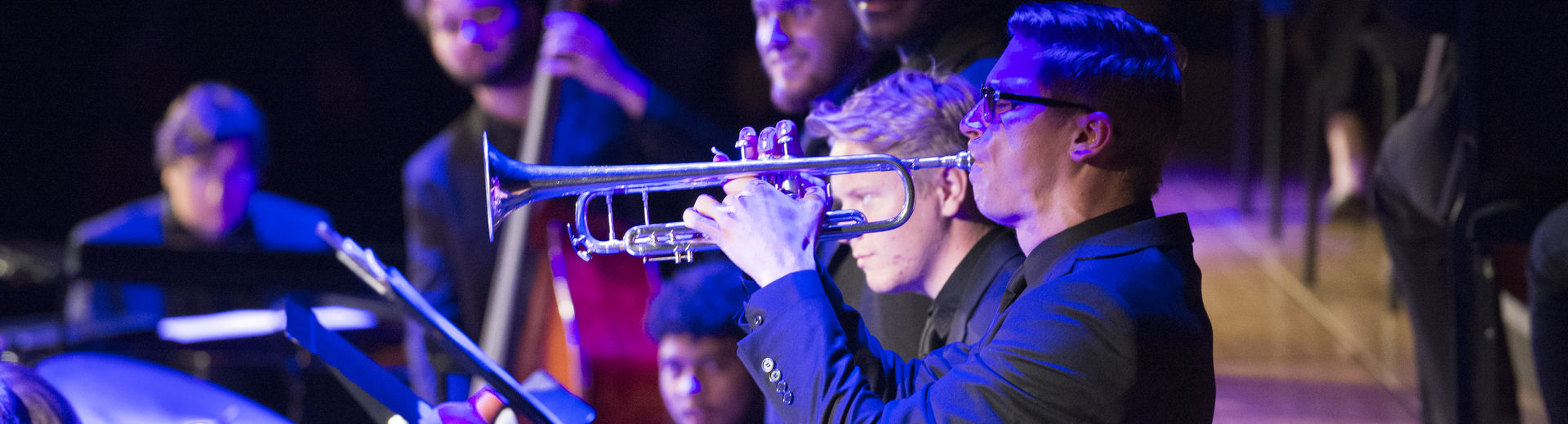 Student playing the trumpet at a live performance. 