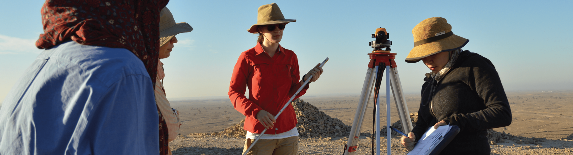 Four Temple Anthropology students participating in fieldwork outdoors.