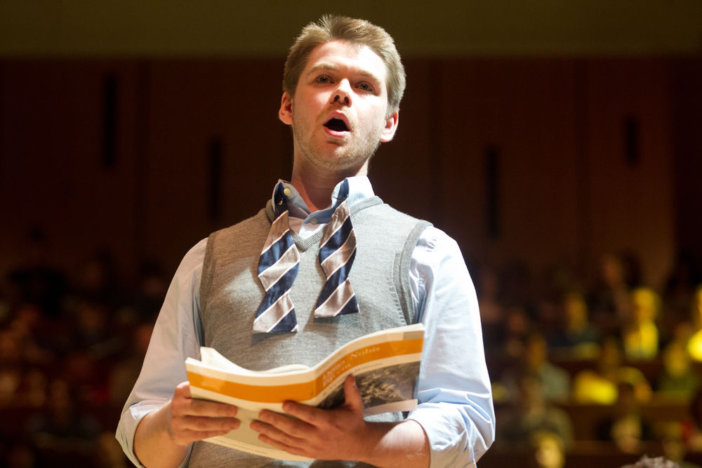 A music student singing on stage.