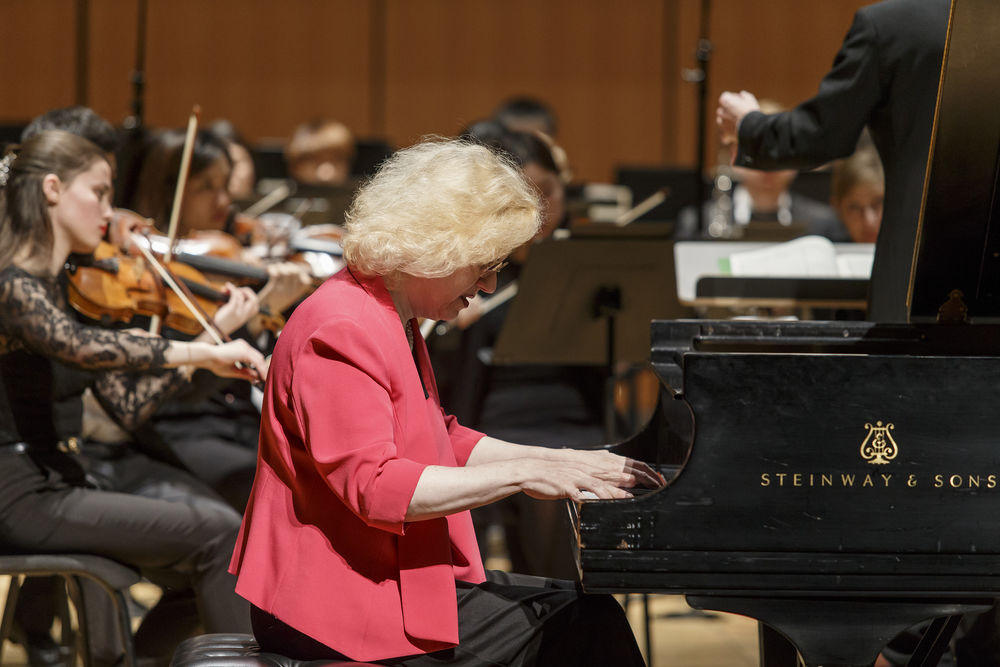 Sara Davis Buechner plays piano with a large ensemble.