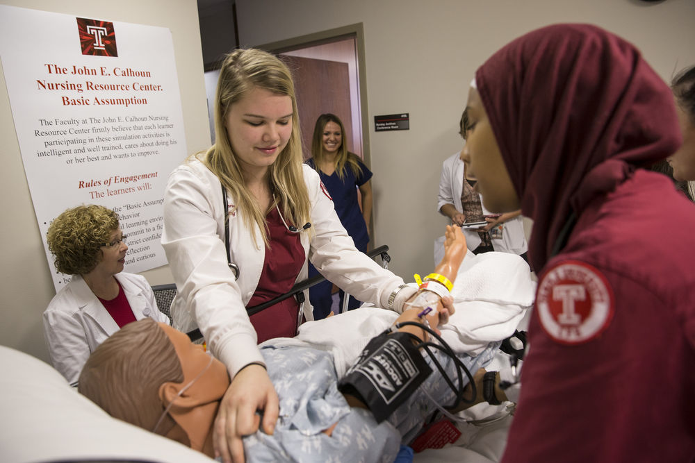 nursing students participate in a simulation. 