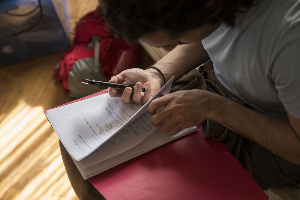 Person looking at a printed theater script. 