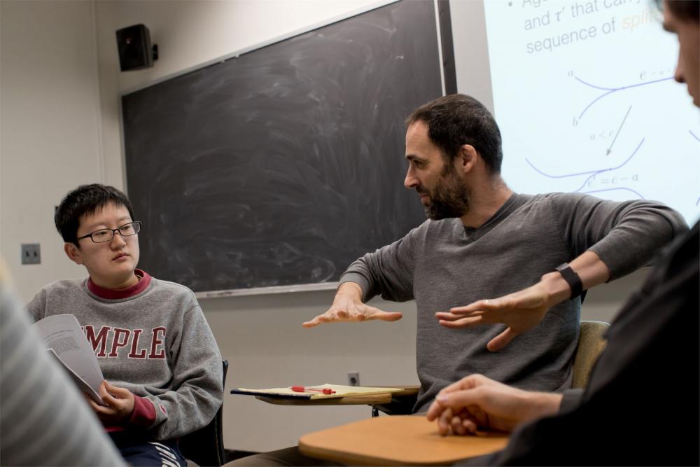 A Temple math professor is talking to his students in a classroom.