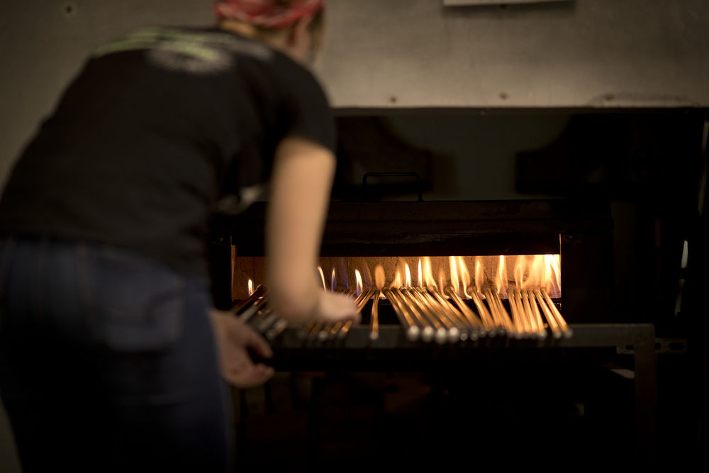 An image of a student placing glass in oven