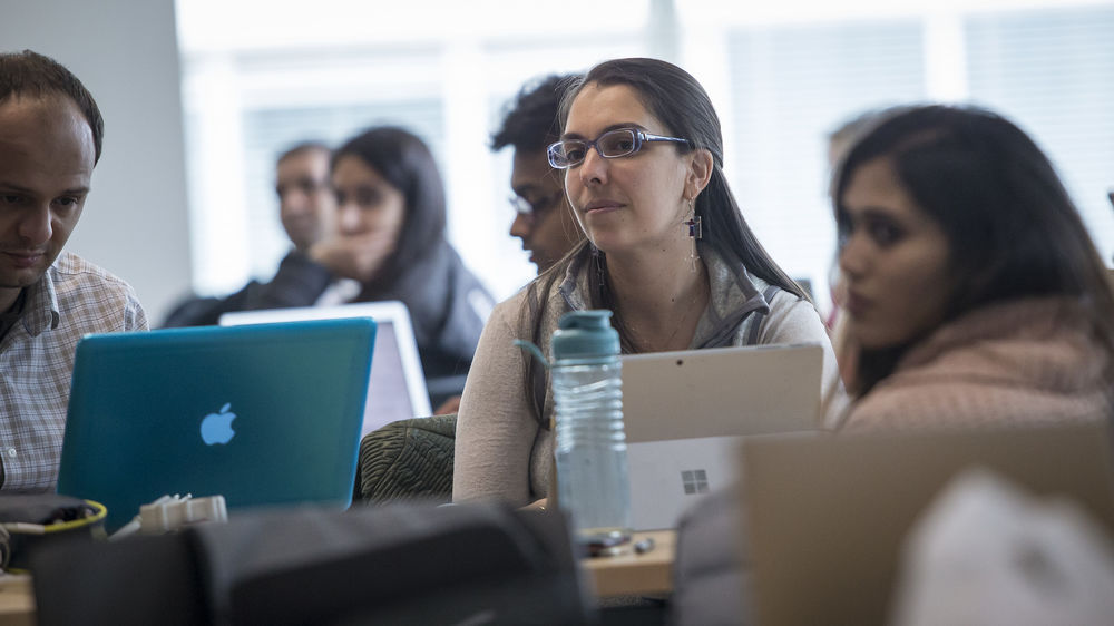 Several students listening in a Temple University Center City campus classroom.