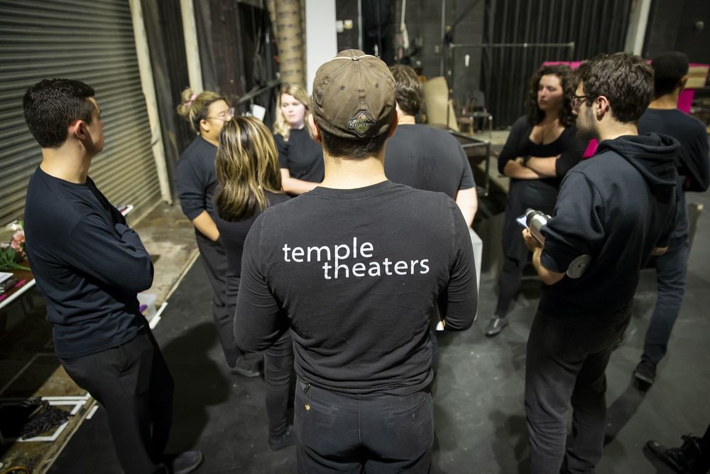 The stage crew standing in a group together.