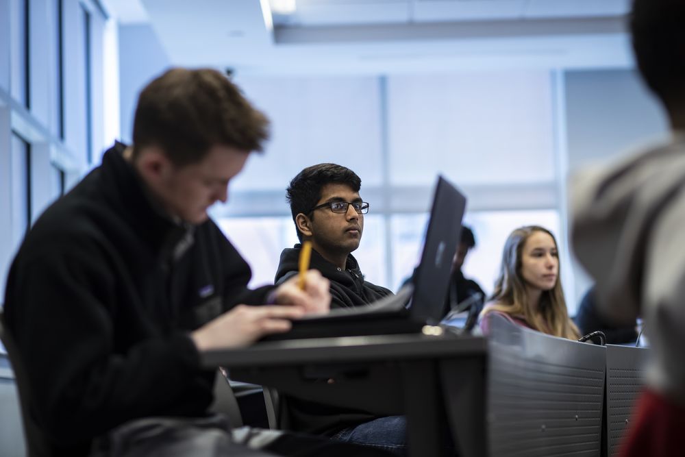 A student attentively listening in class. 