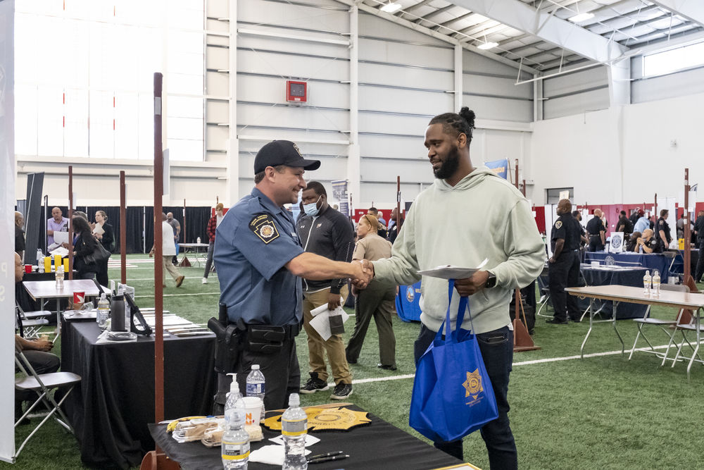 Law enforcement professional speaks to a Temple student interested in entering the field.