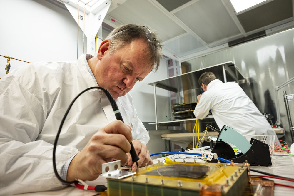 An individual conducting an experiment in a lab. 