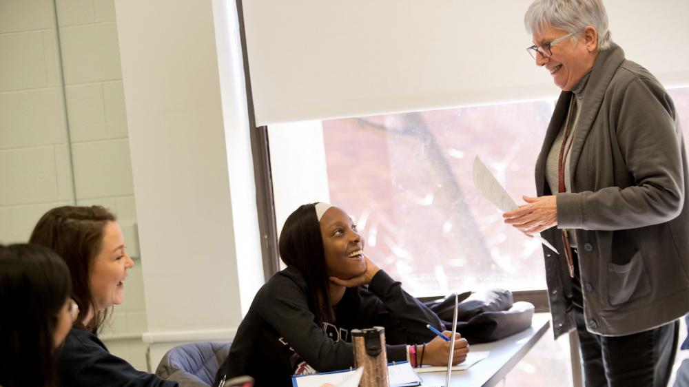 education students and professor interacting in class