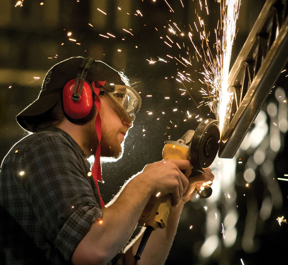 A Temple student works to craft set pieces for a theater production.