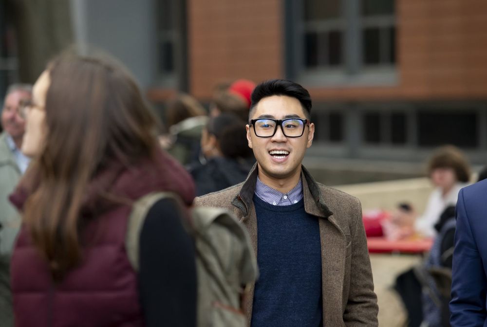 A Fox student talks with his peers outside of Alter Hall.