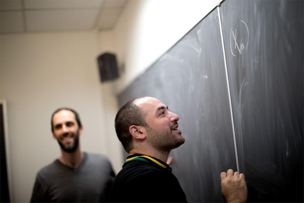  Student figuring out equations with the assistance of dedicated Temple faculty members.