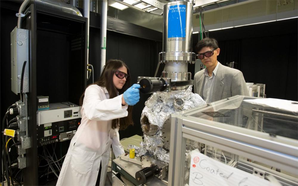 Temple faculty and students using complex machinery in a CST lab