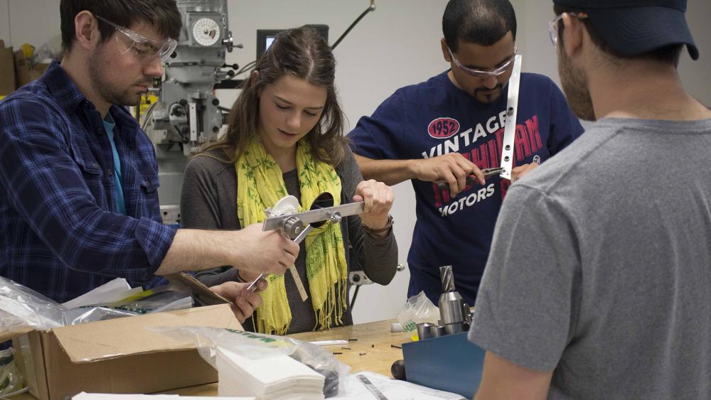 Mechanical engineering students collaborating in class