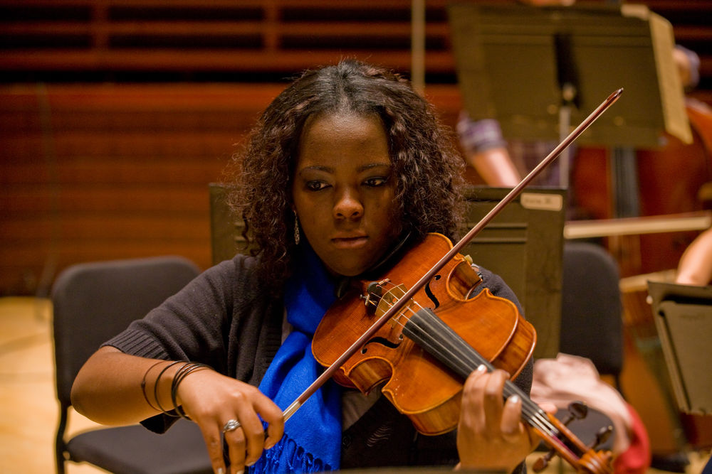 Women playing a violin. 