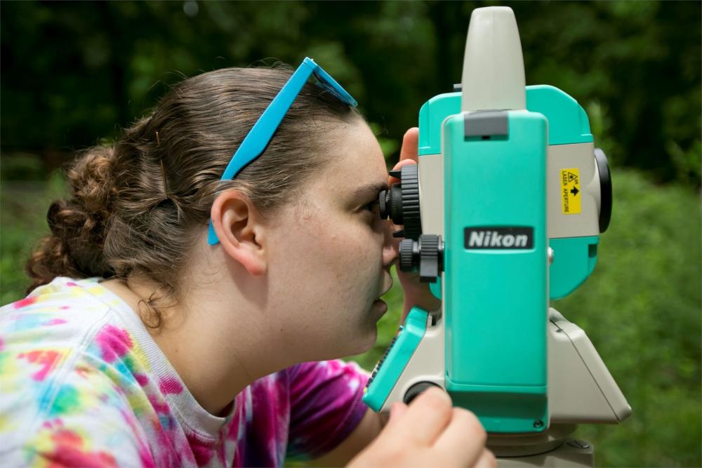 Environmental Science student examining foliage through a microscope